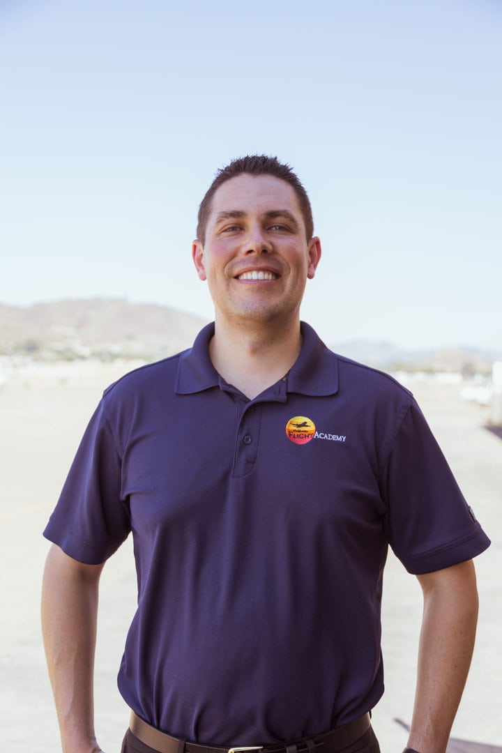 Alexander Garcia, instructor, smiling outdoors on a sunny day.