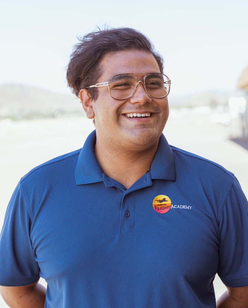 Erick Calderon, smiling instructor in blue uniform.
