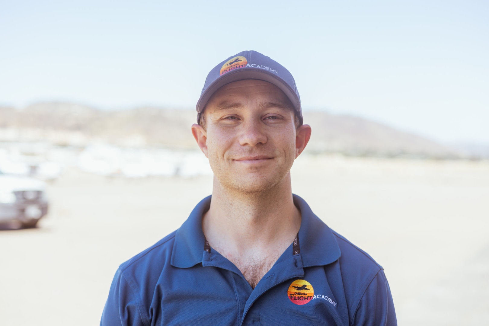 Grant Humphryes, instructor, stands outdoors in casual attire with a cap.
