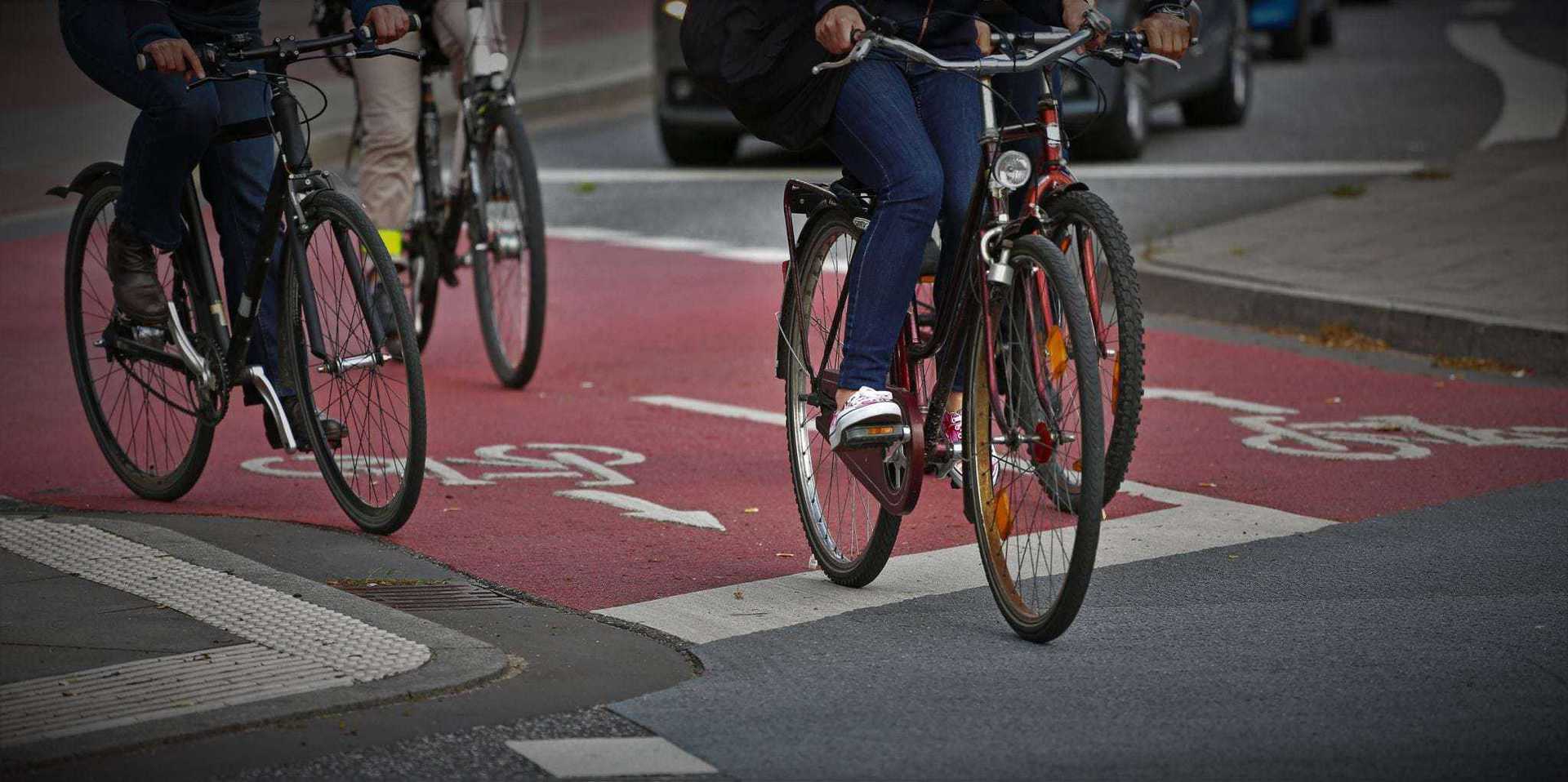 Cyclists riding on a designated bike lane in an urban area.